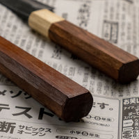 Meet your new favorite power couple - The Carbons. The set consists of Yoshida Ajikiri 100mm (3.9") and Yoshida Santoku Funayuki 155mm (6.1"). Small yet fierce, these two hand-forged knives are made from high-carbon SUJ-2 steel (63-64 HRC), known for its fine sharpness, long edge retention, and ease of sharpening.