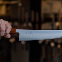 Hokiyama Gyuto SRS13 Migaki 210mm (8.3") is a knife suitable for professional users and home cooks who like low-maintenance knives that offer excellent cutting performance and edge retention, while still being fairly easy to resharpen. Fitted with a unique traditional Japanese handle from oak wood.