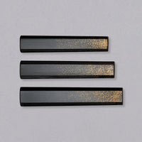 A traditional Japanese handle of octagonal shape, made of oak wood. It does not have a ferrule—instead, gold powder spreads out in its place, slowly fading along the length of the handle, reminiscent of a starry sky. The handle is polished and very glossy yet minimalistic and will give any blade an added dimension of elegance and luxury.