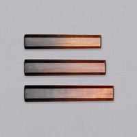 A traditional Japanese handle of octagonal shape, made of oak wood. In an elegant, very glossy gradient, the natural reddish color of the wood slowly darkens from the top toward the bottom of the handle. The octagonal handle offers a good grip and the sleek indentation-free surface ensures easy cleanup and maintenance.