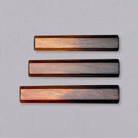 A traditional Japanese handle of octagonal shape, made of oak wood. In an elegant, very glossy gradient, the natural reddish color of the wood slowly darkens from the top toward the bottom of the handle. The octagonal handle offers a good grip and the sleek indentation-free surface ensures easy cleanup and maintenance.