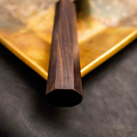 Close-up of the ebony handle of the Kokugei Gyuto Aogami #1 Kuro-uchi Ebony 240mm, featuring the octagonal shape for a secure and comfortable grip, emphasizing the knife's quality and design.