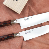 The Mcusta Zanmai Supreme Twisted Knife Set offers great versatility, featuring two multi-purpose knives that cover most cutting tasks in the kitchen. The minimalistic, highly polished blades are made of low-maintenance stainless VG-10 steel and are designed to put the focus on the uniquely shaped twisted handle.