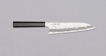Nigara Gyuto VG-10 Damascus Tsuchime 210mm (8.2") is a multi-purpose Japanese kitchen knife, suitable for preparing meat, fish, and vegetables. VG-10 stainless steel ensures a fine sharpness with little to no maintenance. As such, the knife is also suitable as a first Japanese knife or gift. Fitted with an ebony handle.