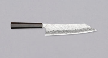 Nigara Kiritsuke Gyuto VG-10 Damascus Tsuchime 240mm (9.4") is a multi-purpose Japanese kitchen knife, suitable for preparing meat, fish, and vegetables. VG-10 stainless steel ensures a fine sharpness with little to no maintenance. As such, the knife is also suitable as a first Japanese knife or gift. Fitted with an ebony handle.