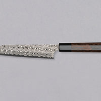 Nigara Kiritsuke Petty SG2 Damascus 150mm is a Japanese kitchen knife suitable for smaller cutting tasks. It's adorned with a raindrop damascus pattern and fitted with a wenge wood handle. Its SG2 powder steel core ensures long-lasting sharpness with little to no maintenance, as the steel resists corrosion very well.