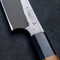 Nigara Kurozome Kiritsuke Yanagiba Aogami #2 Damascus 240mm (9.4") is a traditional single-bevel Japanese knife used for preparing meat and raw fish, especially sashimi and nigiri sushi, and meat. Its length allows the user to slice different types of protein in one single pulling motion, that will – together with the razor-sharp single bevel blade – birth smooth, shiny cuts.