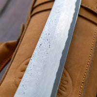 Nigara Kurozome Kiritsuke Yanagiba Aogami #2 Damascus 240mm (9.4") is a traditional single-bevel Japanese knife used for preparing meat and raw fish, especially sashimi and nigiri sushi, and meat. Its length allows the user to slice different types of protein in one single pulling motion, that will – together with the razor-sharp single bevel blade – birth smooth, shiny cuts.