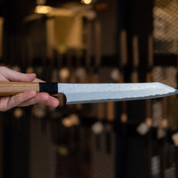 Nigara Kurozome Kiritsuke Yanagiba Aogami #2 Damascus 240mm (9.4") is a traditional single-bevel Japanese knife used for preparing meat and raw fish, especially sashimi and nigiri sushi, and meat. Its length allows the user to slice different types of protein in one single pulling motion, that will – together with the razor-sharp single bevel blade – birth smooth, shiny cuts.