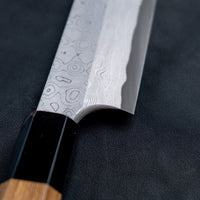 Nigara Kurozome Sakimaru Yanagiba Aogami #2 Damascus 270mm (10.6") is a traditional single-bevel Japanese knife used for preparing meat and raw fish, especially sashimi and nigiri sushi, and meat. Its length allows the user to slice different types of protein in one single pulling motion.