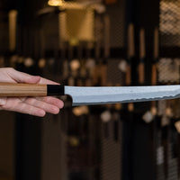 Nigara Kurozome Sakimaru Yanagiba Aogami #2 Damascus 270mm (10.6") is a traditional single-bevel Japanese knife used for preparing meat and raw fish, especially sashimi and nigiri sushi, and meat. Its length allows the user to slice different types of protein in one single pulling motion.