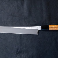 Nigara Kurozome Sakimaru Yanagiba Aogami #2 Damascus 270mm (10.6") is a traditional single-bevel Japanese knife used for preparing meat and raw fish, especially sashimi and nigiri sushi, and meat. Its length allows the user to slice different types of protein in one single pulling motion.