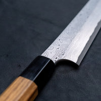 Nigara Kurozome Sakimaru Yanagiba Aogami #2 Damascus 270mm (10.6") is a traditional single-bevel Japanese knife used for preparing meat and raw fish, especially sashimi and nigiri sushi, and meat. Its length allows the user to slice different types of protein in one single pulling motion.
