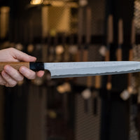 The quality and craftsmanship of this Nigara Kurozome Yanagiba Aogami #2 Damascus 270mm (10.6") is simply superb - from the beautifully polished choil to the unique damascus pattern that surrounds the spine of the blade and extends to its back. The outer layers of the blade have a pearl mosaic-like appearance, which you won't find often even in the most high-end blades.