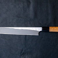 The quality and craftsmanship of this Nigara Kurozome Yanagiba Aogami #2 Damascus 270mm (10.6") is simply superb - from the beautifully polished choil to the unique damascus pattern that surrounds the spine of the blade and extends to its back. The outer layers of the blade have a pearl mosaic-like appearance, which you won't find often even in the most high-end blades.
