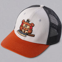 SharpEdge exclusive merch: SharpEdge x Vincent Trinidad Trucker Hat Exclusive SharpEdge design of a brown sumo-fighting bear, armed with our ZDP-189 Bunka Black Japanese knife in collaboration with artist Vincent Trinidad. The bottom of the sturdy visor features the SharpEdge logo within a Japanese rising sun.