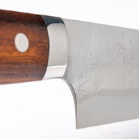 Handle of knife. Saji Gyuto SRS13 Tsuchime 240mm (9.4") is a multi-purpose Japanese kitchen knife, suitable for preparing meat, fish, and vegetables. It’s a truly out-of-this-world piece of knifemaking. Its heart was forged out of SRS13, a high-speed powder steel, renowned for its high hardness and excellent corrosion resistance.