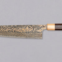 The Saji Gyuto VG-10 Gold RWO 240mm is a high-quality, multi-purpose Japanese knife crafted by Takeshi Saji of Takefu Knife Village. It has a special lamination process where brass is added to the outer layers to achieve a gold-colored damascus pattern. It's made from stainless VG-10 steel and has a rosewood wa handle.