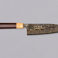 Saji Santoku VG-10 Gold RWO 165mm is a versatile Japanese kitchen knife suitable for preparing meat, fish and vegetables. However, it would be an injustice to call it just a kitchen knife, as it is a remarkable example of blacksmith's craftsmanship - from its unique design to its very specific features.