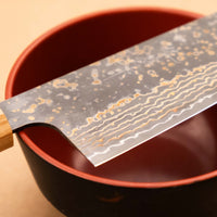 Saji Santoku VG-10 Gold RWO 165mm is a versatile Japanese kitchen knife suitable for preparing meat, fish and vegetables. However, it would be an injustice to call it just a kitchen knife, as it is a remarkable example of blacksmith's craftsmanship - from its unique design to its very specific features.