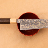 Saji Santoku VG-10 Gold RWO 165mm is a versatile Japanese kitchen knife suitable for preparing meat, fish and vegetables. However, it would be an injustice to call it just a kitchen knife, as it is a remarkable example of blacksmith's craftsmanship - from its unique design to its very specific features.