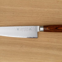 Tamahagane Gyuto is an all-rounder when it comes to knives, designed for a wide range of kitchen tasks. It will excel at chopping vegetables and slicing larger cuts of meat. The narrow tip can be used for tasks where precision is key. A true workhorse, that will ease long hours of food prep in a professional kitchen. The core of the blade has a high-polish finish and is forged out of VG-5 (High Carbon Molybdenum Vanadium Steel) steel hardened to 61 HRC.
