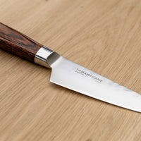 Tamahagane Paring knife is mostly used for in-hand cutting for peeling, paring and decorating, trimming meat, coring apples, cutting out potato eyes and similar tasks. A matte blade finish, featured with the core VG-5 steel hardened to 61 HRC.