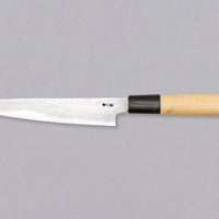 The minimalistic, lightweight petty was forged by the famous Shigeki Tanaka. It comes in a traditional Japanese paulownia wood box and makes a truly special gift. The superior Aogami #2 steel ensures long-lasting sharpness and easy sharpening. It's fitted with a traditional magnolia handle in D-shape.