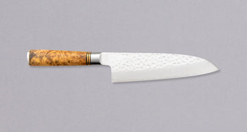 Saji Santoku R2 Karin 180mm is a multi-purpose Japanese kitchen knife, suitable for meat, fish, and vegetables. R2/SG2 is steel without compromises – high hardness of 64 HRC, great corrosion resistance, and easy sharpening. The blade is dotted with minuscule circular hammer imprints and fitted with Chinese quince.