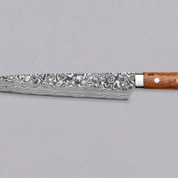 Saji Sujihiki Rainbow Damascus 240mm (9.5") is definitely not just a looker. The core is made of R2/SG2 powder steel, tempered to 63-64 HRC, clad into layers of rust-resistant stainless steel, to which nickel was added to get a unique dark Damascus pattern. Fitted with an ironwood handle. A great example of usable art!