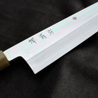 Kawamura Mizu-Honyaki Gyuto is a hand-forged masterpiece. Crafted with incredible precision, it is not simply a Japanese knife but a piece of art. On one side it is adorned with Mt Fuji and a full moon, which is replaced with a crescent on the other. A stunning collector's item, this Shirogami #2 steel honyaki blade with a rainbow sheen is forged from a single piece of high-carbon Yasuki Shirogami (White Steel) #2.
