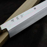 Kawamura Mizu-Honyaki Gyuto is a hand-forged masterpiece. Crafted with incredible precision, it is not simply a Japanese knife but a piece of art. On one side it is adorned with Mt Fuji and a full moon, which is replaced with a crescent on the other. A stunning collector's item, this Shirogami #2 steel honyaki blade with a rainbow sheen is forged from a single piece of high-carbon Yasuki Shirogami (White Steel) #2.