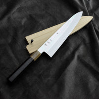 Kawamura Mizu-Honyaki Gyuto is a hand-forged masterpiece. Crafted with incredible precision, it is not simply a Japanese knife but a piece of art. On one side it is adorned with Mt Fuji and a full moon, which is replaced with a crescent on the other. A stunning collector's item, this Shirogami #2 steel honyaki blade with a rainbow sheen is forged from a single piece of high-carbon Yasuki Shirogami (White Steel) #2.