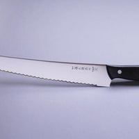 Micarta Pankiri (Bread Knife) 270mm (10.6")_3  A hand-forged Tojiro Micarta 270mm (10.6") bread knife with a compact black woods handle and a long blade (270 mm) is an indispensable tool for either professional chefs or passionate home cooks (sourdough enthusiasts, raise your hands!). The blade is made from Molybdenum Vanadium steel with 57–59 HRC.