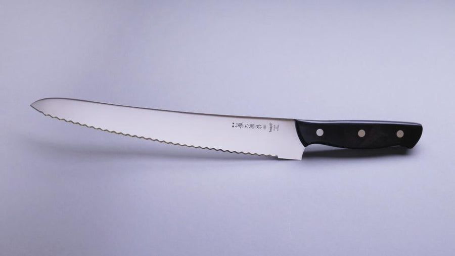 Micarta Pankiri (Bread Knife) 270mm (10.6")_3  A hand-forged Tojiro Micarta 270mm (10.6") bread knife with a compact black woods handle and a long blade (270 mm) is an indispensable tool for either professional chefs or passionate home cooks (sourdough enthusiasts, raise your hands!). The blade is made from Molybdenum Vanadium steel with 57–59 HRC.