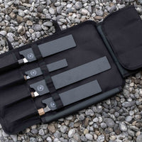 Our SharpEdge Black Chef's Knife Roll is best suited for chefs on-the-go and home cooks who need a small knife roll that can still hold very long knives (up to 440mm (17.3")). It has 4 pockets for knives and utensils, and additional velcro fasteners to keep them in place. A minimalistic, durable black knife bag.