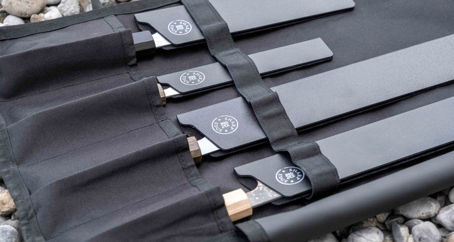 Our SharpEdge Black Chef's Knife Roll is best suited for chefs on-the-go and home cooks who need a small knife roll that can still hold very long knives (up to 440mm (17.3")). It has 4 pockets for knives and utensils, and additional velcro fasteners to keep them in place. A minimalistic, durable black knife bag.