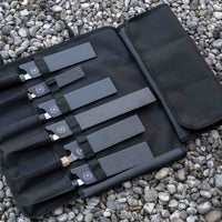 Our SharpEdge Black Chef's Knife Roll is best suited for chefs on-the-go and home cooks who need a sturdy knife roll that can hold very long knives (up to 440mm (17.3")). It has 6 pockets for knives and utensils, and additional velcro fasteners to keep them in place. A minimalistic, durable black knife bag. Get yours.