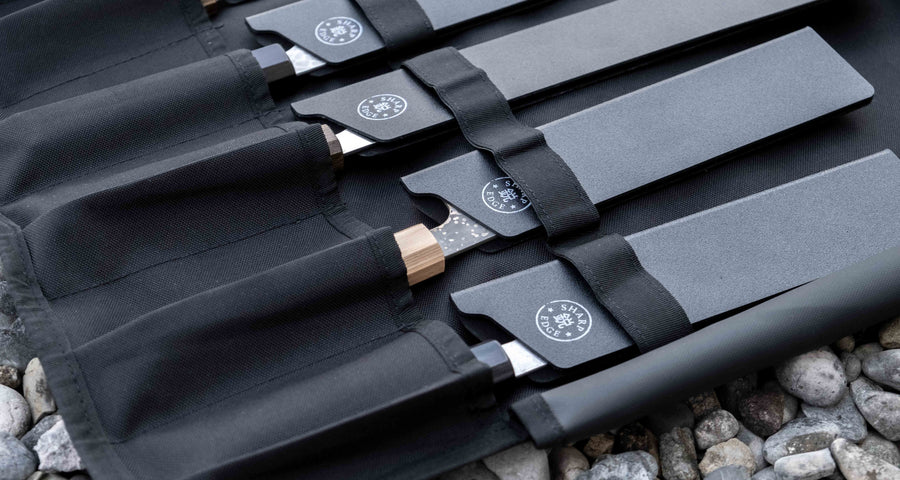 Our SharpEdge Black Chef's Knife Roll is best suited for chefs on-the-go and home cooks who need a sturdy knife roll that can hold very long knives (up to 440mm (17.3")). It has 6 pockets for knives and utensils, and additional velcro fasteners to keep them in place. A minimalistic, durable black knife bag. Get yours.