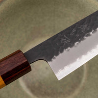 Hokiyama Bunka AS Kurouchi 170mm (6.7") is a multi-purpose knife that will handle all sorts of cutting techniques and is great for preparing fish, meat, and vegetables. Its Aogami Super steel core is protected with san-mai lamination. Fitted with an octagonal Japanese wa handle, made of mahogany and zelkova wood.