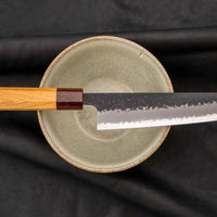 Hokiyama Bunka AS Kurouchi 170mm (6.7") is a multi-purpose knife that will handle all sorts of cutting techniques and is great for preparing fish, meat, and vegetables. Its Aogami Super steel core is protected with san-mai lamination. Fitted with an octagonal Japanese wa handle, made of mahogany and zelkova wood.