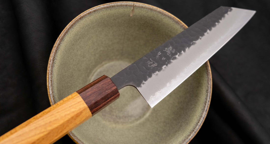 Hokiyama Bunka AS Kurouchi 170mm (6.7") is a multi-purpose knife that will handle all sorts of cutting techniques and is great for preparing fish, meat, and vegetables. Its Aogami Super steel core is protected with san-mai lamination. Fitted with an octagonal Japanese wa handle, made of mahogany and zelkova wood.