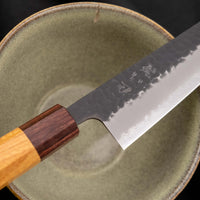 Hokiyama Bunka AS Kurouchi 170mm (6.7") is a multi-purpose knife that will handle all sorts of cutting techniques and is great for preparing fish, meat, and vegetables. Its Aogami Super steel core is protected with san-mai lamination. Fitted with an octagonal Japanese wa handle, made of mahogany and zelkova wood.