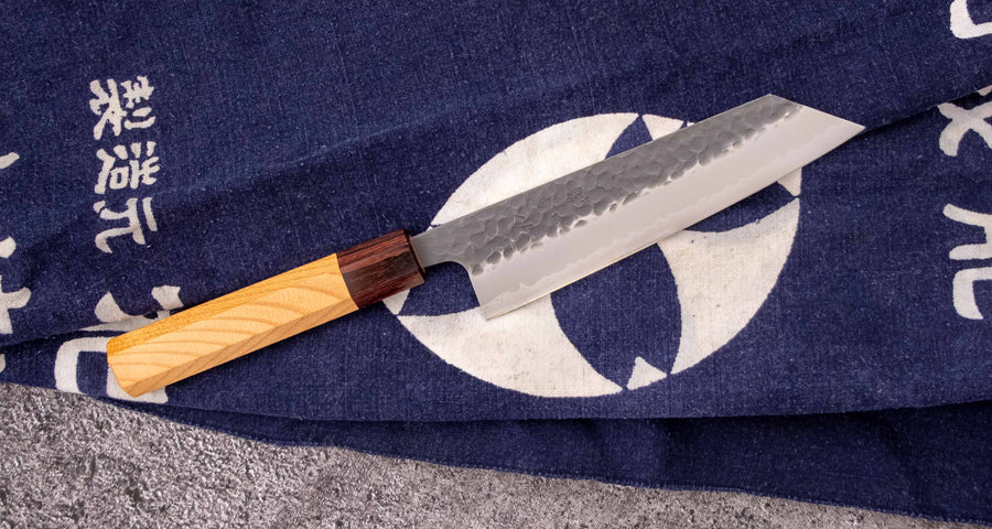 Hokiyama Bunka AS Kurouchi 170mm (6.7") is a multi-purpose knife that will handle all sorts of cutting techniques and is great for preparing fish, meat, and vegetables. Its Aogami Super steel core is protected with san-mai lamination. Fitted with an octagonal Japanese wa handle, made of mahogany and zelkova wood.