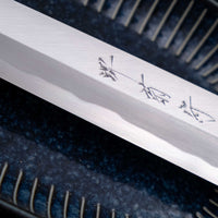 Kawamura Kiritsuke Yanagiba Aogami #1 300mm (11.8") LEFT is one of the rare blades only suitable for left-handed users! It originates from one of the most famous knifemaking centre of Japan, where it was handcrafted by master blacksmiths of the Sakai Kikumori smithy and represents the pinnacle of Japanese knifemaking.