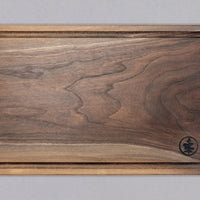 These steak cutting boards are handcrafted by Slovenian woodworker J. Gros and made from American walnut, known for strength and durability. This large cutting board is ideal for comfortable chopping at home or in a professional kitchen. Its size and grain pattern also make it a great presentation or serving board.