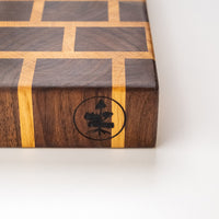 This cutting board is made of American walnut and oak wood. In comparison to edge grain boards, end grain cutting boards are gentler to the knife's edge and have a "self-healing" property - the wood fibers close up after they have been cut, making the board more antibacterial. Natural mineral oil (50ml) is included.