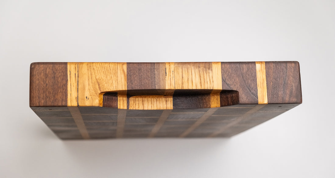 This cutting board is made of American walnut and oak wood. In comparison to edge grain boards, end grain cutting boards are gentler to the knife's edge and have a "self-healing" property - the wood fibers close up after they have been cut, making the board more antibacterial. Natural mineral oil (50ml) is included.