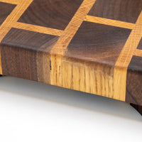 This cutting board is made of American walnut and oak wood. In comparison to edge grain boards, end grain cutting boards are gentler to the knife's edge and have a "self-healing" property - the wood fibers close up after they have been cut, making the board more antibacterial. Natural mineral oil (50ml) is included.