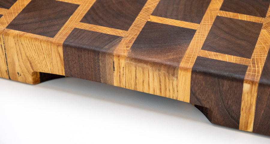 This cutting board is made of American walnut and oak wood. In comparison to edge grain boards, end grain cutting boards are gentler to the knife's edge and have a "self-healing" property - the wood fibers close up after they have been cut, making the board more antibacterial. Natural mineral oil (50ml) is included.